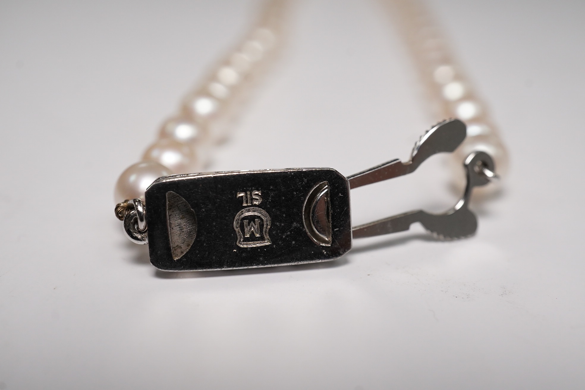 A Mikimoto single strand cultured pearl necklace, 36cm, with Mikimoto pouch. Condition - fair to good